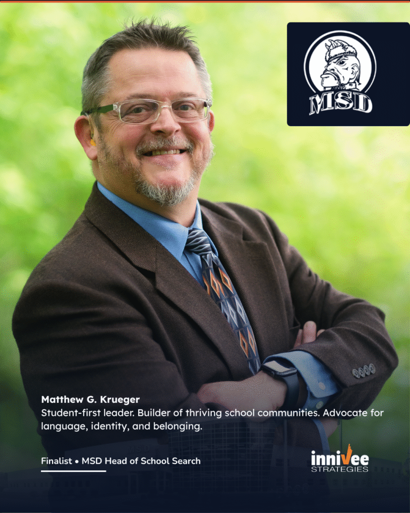 Finalists Announced for Michigan School for the Deaf 3 A professional headshot of Matthew G. Krueger, a white man with short dark-blond hair, glasses, and a trimmed beard. He wears a suit jacket and tie, standing outside with green trees in the background. The MSD logo is in the upper right. Below the photo, text reads:
“Matthew G. Krueger
Student-first leader. Builder of thriving school communities. Advocate for language, identity, and belonging.
Finalist • MSD Head of School Search”
The Innivee Strategies logo is at the bottom right over a faded school building background.