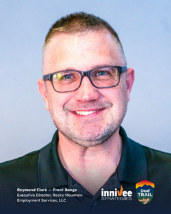Smiling headshot of a person with very short hair, black rectangular glasses, and light facial hair, wearing a dark collared shirt against a light blue-gray background. Bottom text reads “Raymond Clark — Front Range” and “Executive Director, Rocky Mountain Employment Services, LLC,” with inniVee Strategies and Deaf TRAIL logos at bottom right.