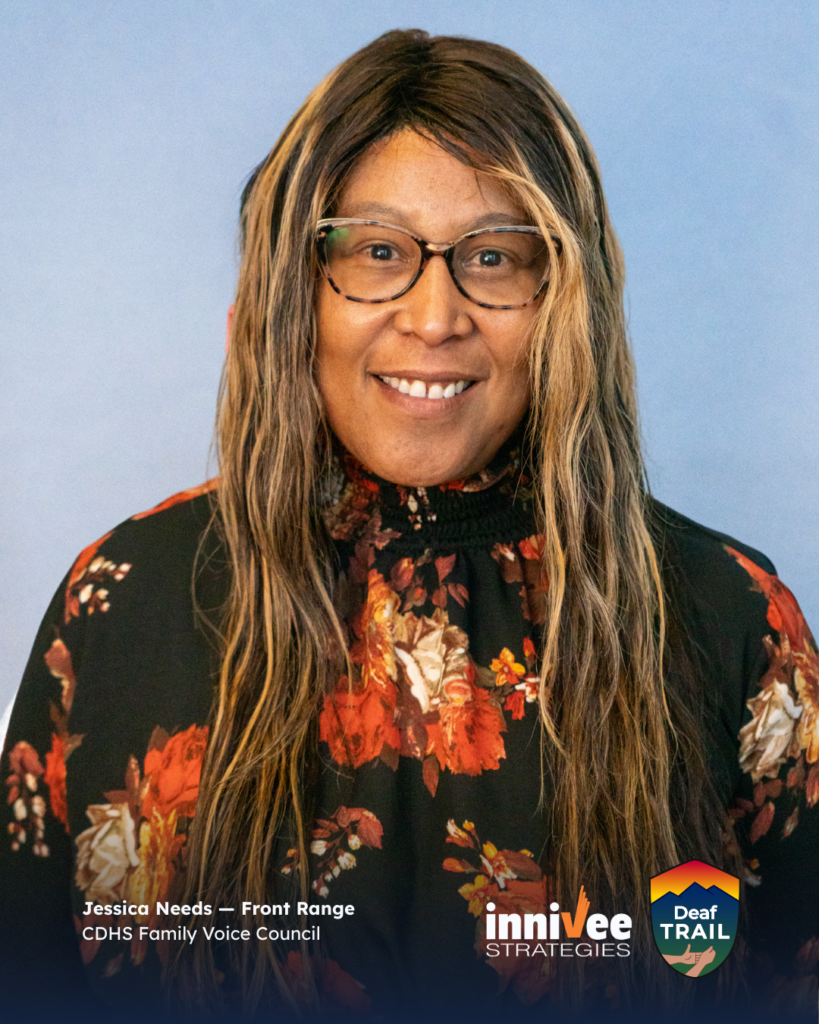 Deaf TRAIL Is Underway: Introducing Colorado’s First Cohort 5 Smiling headshot of a person with long highlighted hair and patterned glasses, wearing a dark floral top against a light blue-gray background. Bottom-left text shows name and affiliation; inniVee Strategies and Deaf TRAIL logos at bottom right.